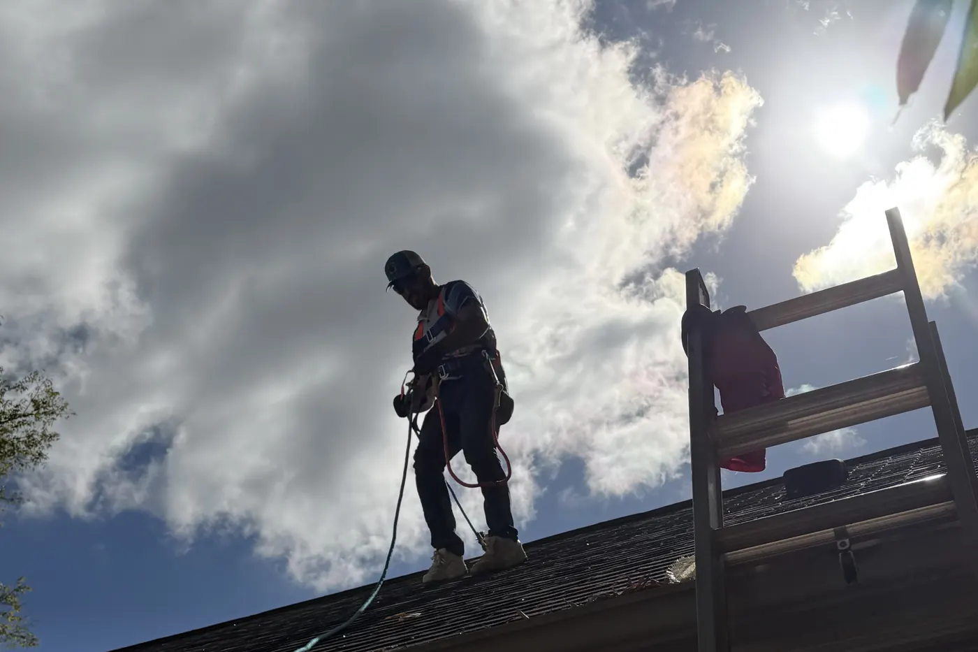 Spraying roof rejuvenation treatment on a Roof Armor job under a big Carolina sky